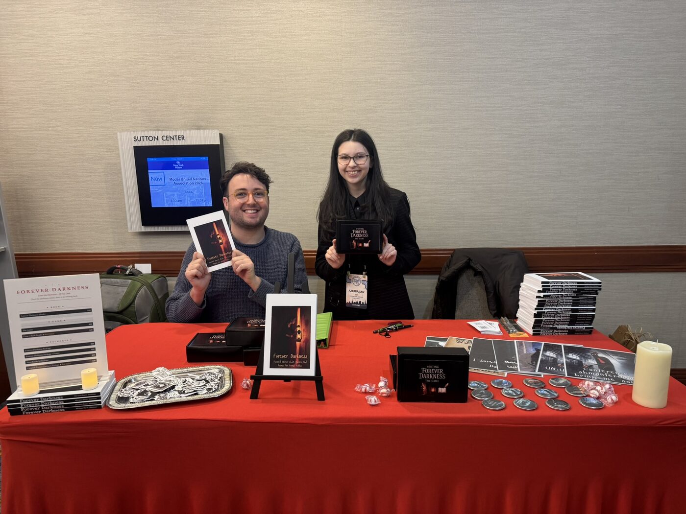 Ma'ayan holding the Forever Darkness book and game at NHSMUN