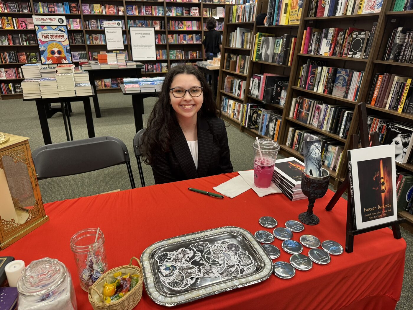 Forever Darkness custom pins on display at a signing table